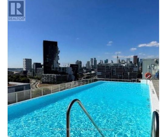 A swimming pool on a rooftop with a cityscape in the background.