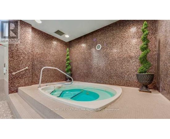 A hot tub in a room with brown walls.