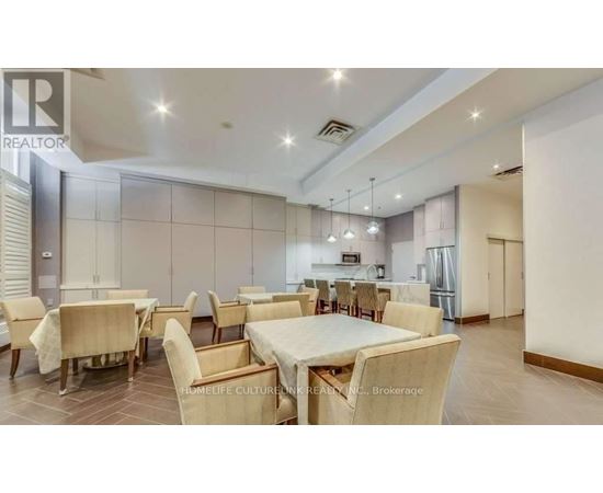 A dining room with a table set for six people.