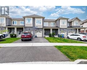 A row of houses with cars parked in front.