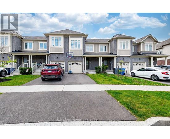 A row of houses with cars parked in front.
