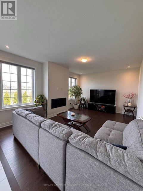 A living room with a grey sofa and a television.