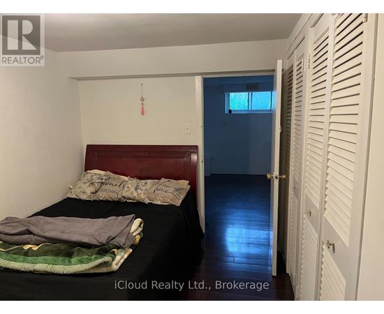 A bedroom with a bed, a window, and a door.