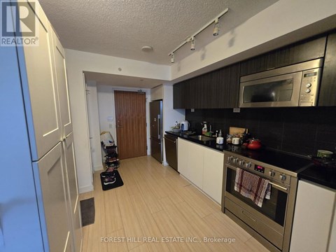 A kitchen with a stove top oven and a microwave above it.