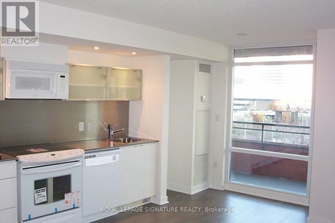 A kitchen with a white oven and microwave.
