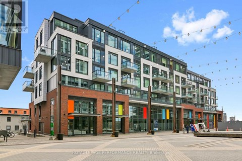 A modern building with glass windows and balconies is shown.