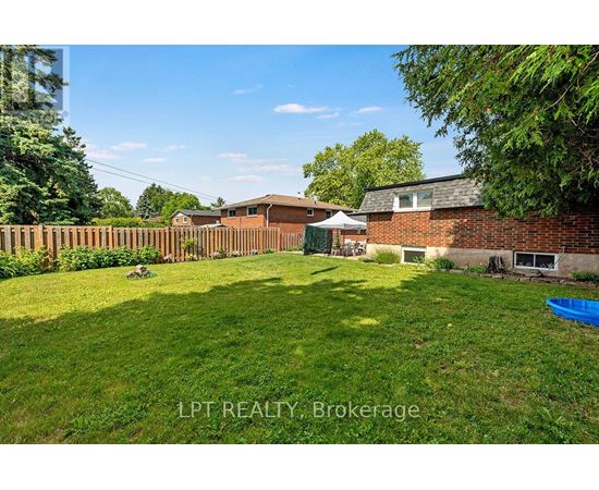 A backyard with a blue kiddie pool and a white umbrella.