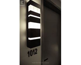A black and white sign with the number 1012 on it.
