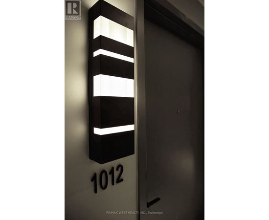 A black and white sign with the number 1012 on it.
