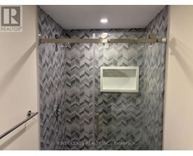 A bathroom with a shower curtain and a glass door.