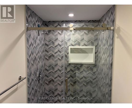 A bathroom with a shower curtain and a glass door.
