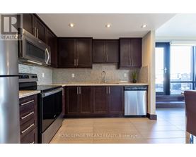 A kitchen with brown cabinets and a stainless steel refrigerator.