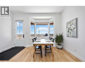 A dining room with a table set for four.