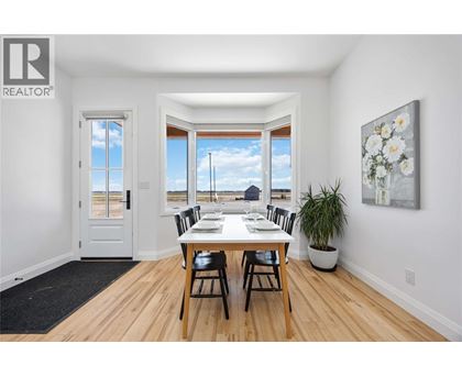 A dining room with a table set for four.