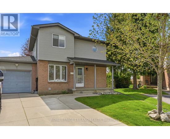A house with a grey roof and a white garage door is for sale.