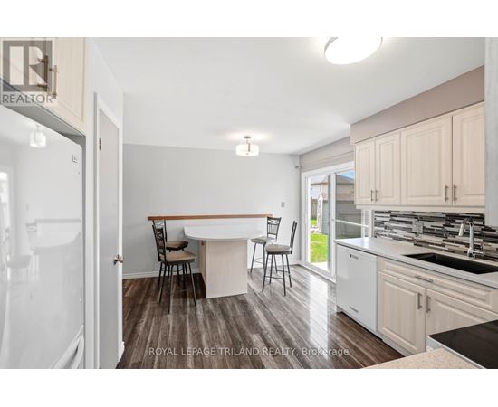 A kitchen with a table and chairs in the middle of the room.