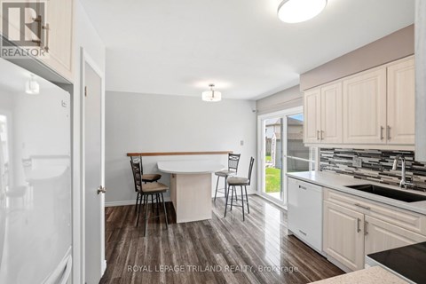 A kitchen with a table and chairs in the middle of the room.