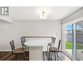 A dining room with a white table and chairs.