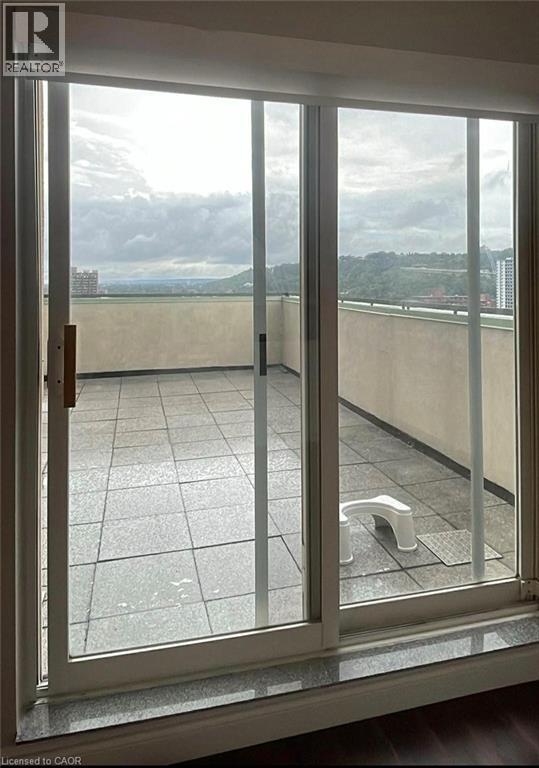 A view from a window of a balcony with a glass door.