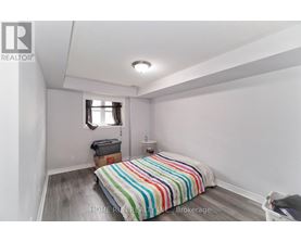 A bedroom with a bed and a window.