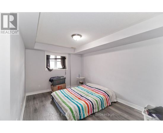 A bedroom with a bed and a window.