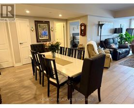 A dining room with a table set for six with chairs around it.