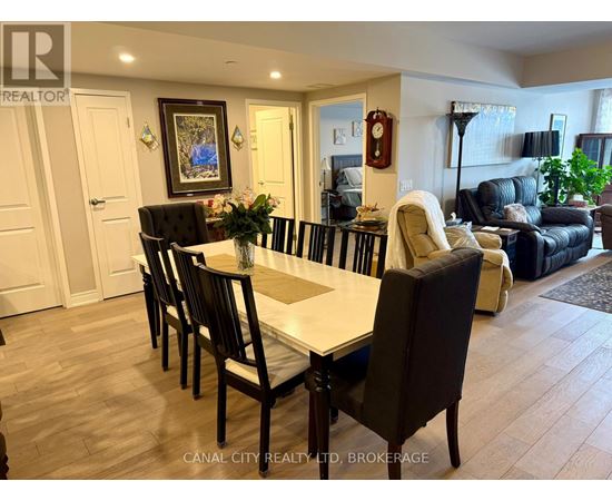A dining room with a table set for six with chairs around it.