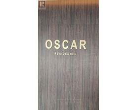 A book cover with the title "Oscar Residences" on a wood grain background.