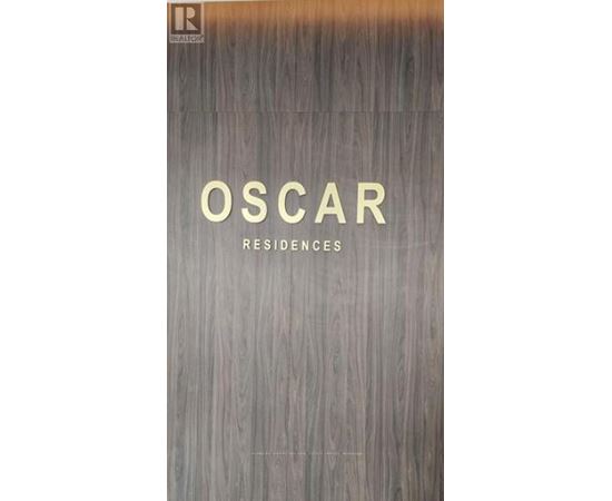 A book cover with the title "Oscar Residences" on a wood grain background.