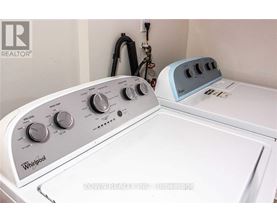 A Whirlpool washing machine and dryer are sitting next to each other.