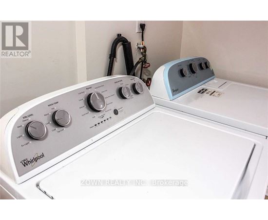 A Whirlpool washing machine and dryer are sitting next to each other.