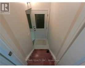 A stairway with a glass door leading to a landing.