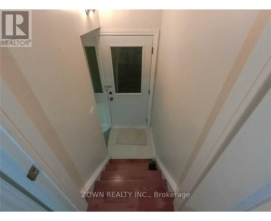 A stairway with a glass door leading to a landing.