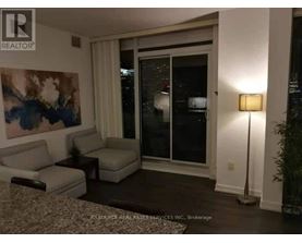 A living room with a couch, chair, and lamp.