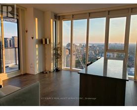 A room with a view of the cityscape through large windows.