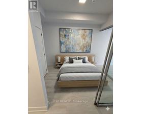 A bedroom with a bed, nightstands, and a painting on the wall.