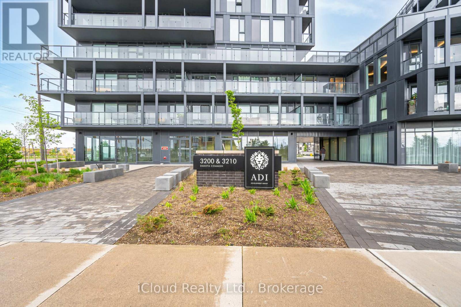 The image shows a modern building with a sign that reads "ADI" in front of it.