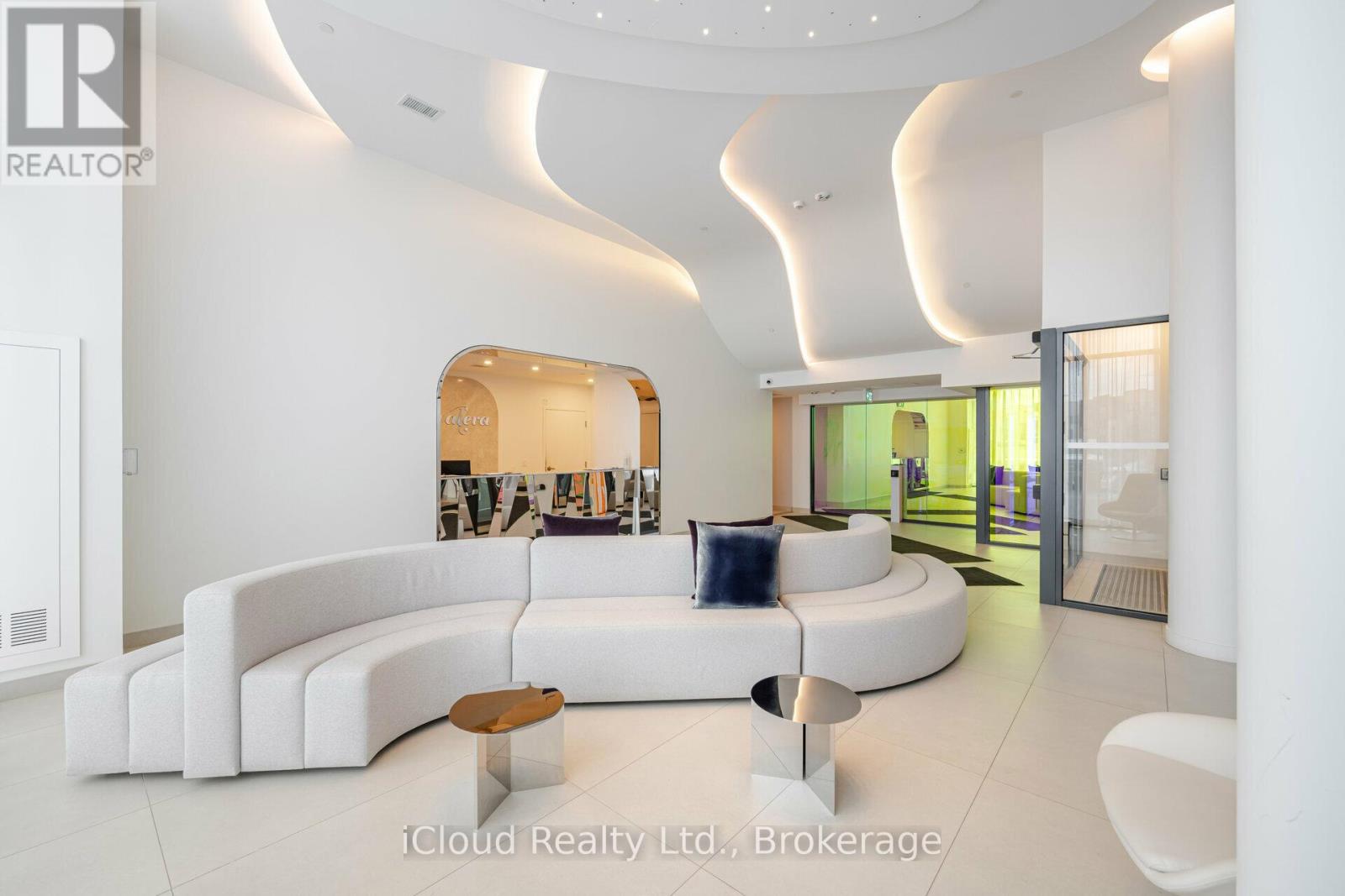 A modern living room with a white sofa and a wooden coffee table.
