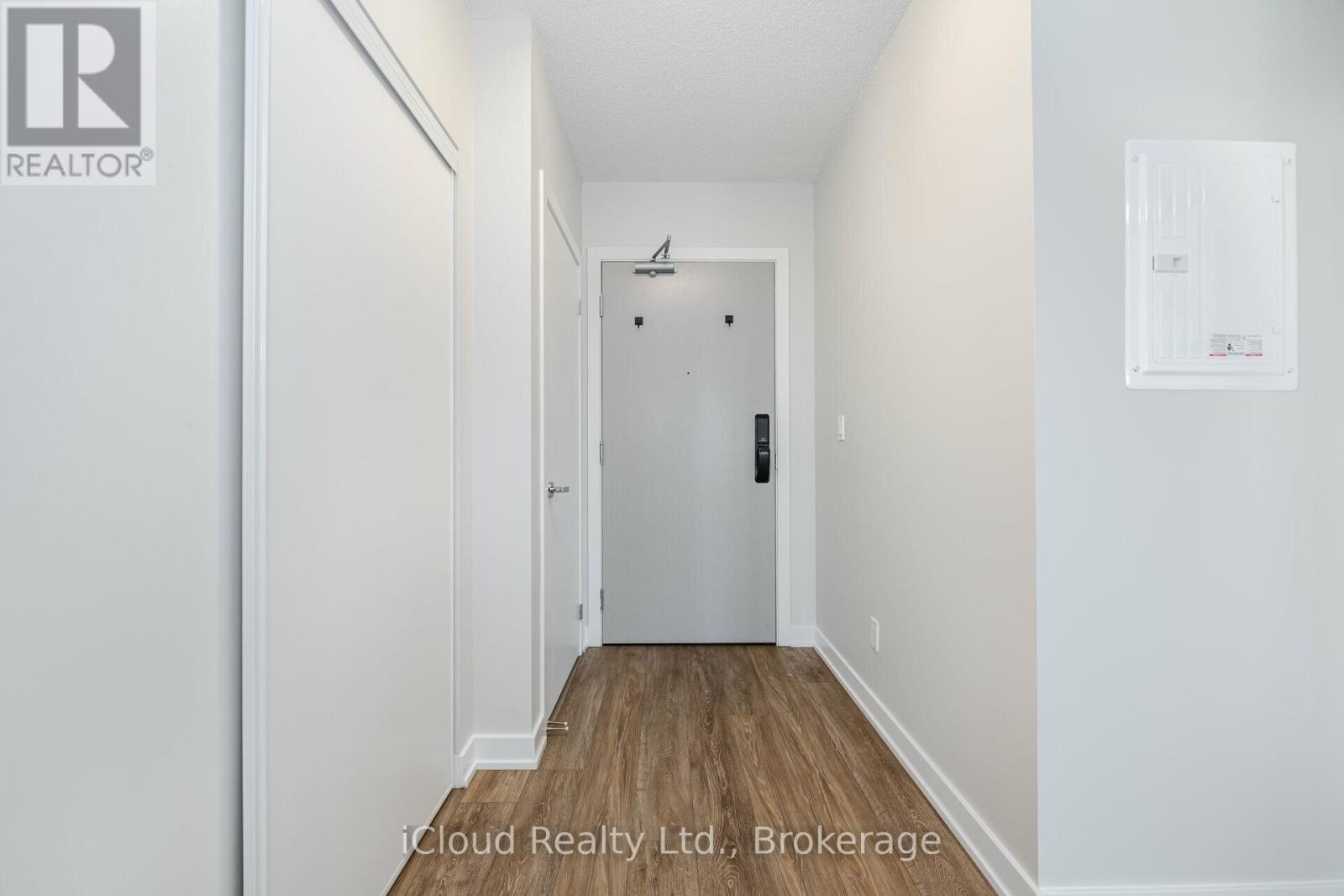 A hallway with a door at the end.