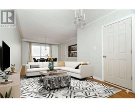 A living room with a white couch, a coffee table, and a chandelier.