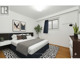 A bedroom with a bed, nightstand, and a plant.
