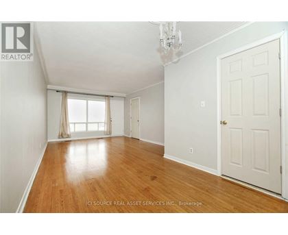 A room with wooden floors and white walls.