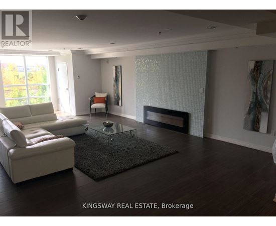 A living room with a white sofa and a glass coffee table.
