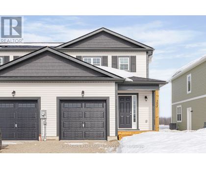 A house with a grey roof and a grey garage door.
