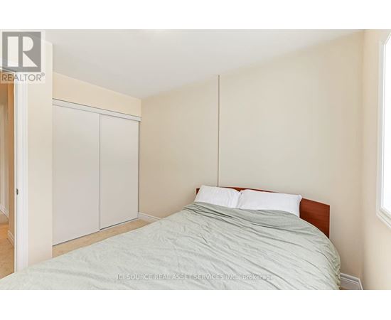 A bedroom with a bed, a wardrobe and a window.