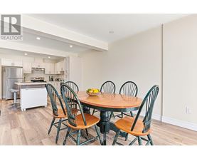 A dining room with a table and chairs.