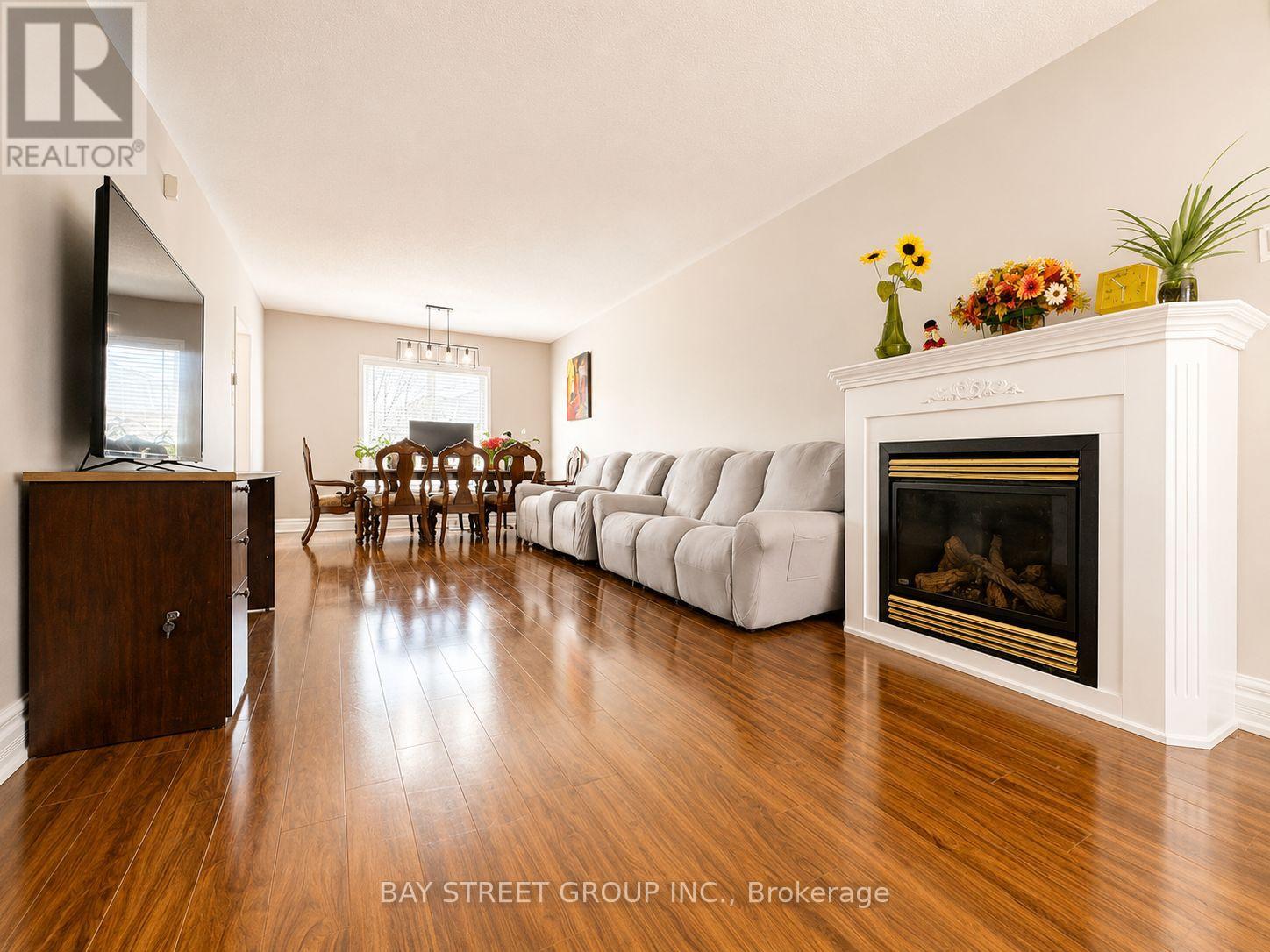 A living room with a fireplace and a tv.