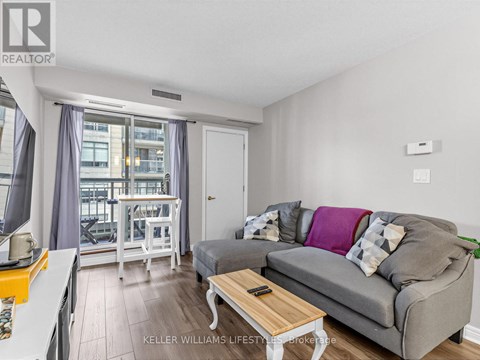 A living room with a grey couch and a coffee table.