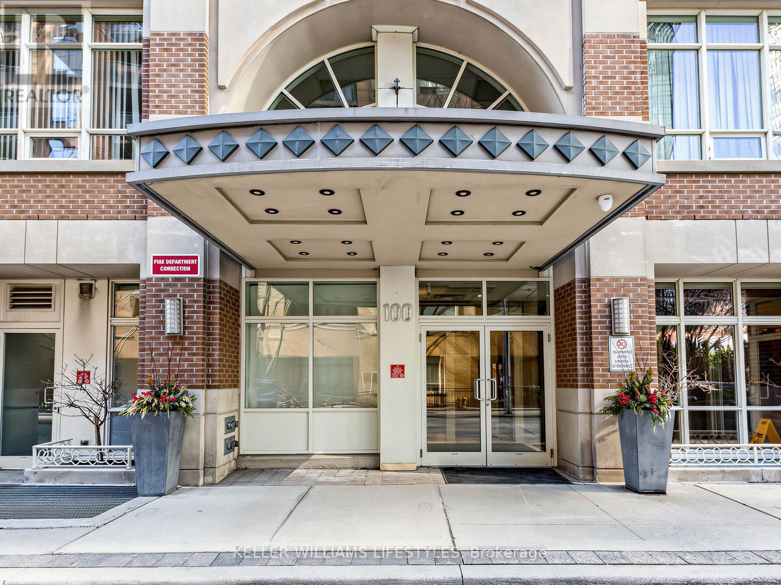 The front of a building with a glass door and a sign above it.