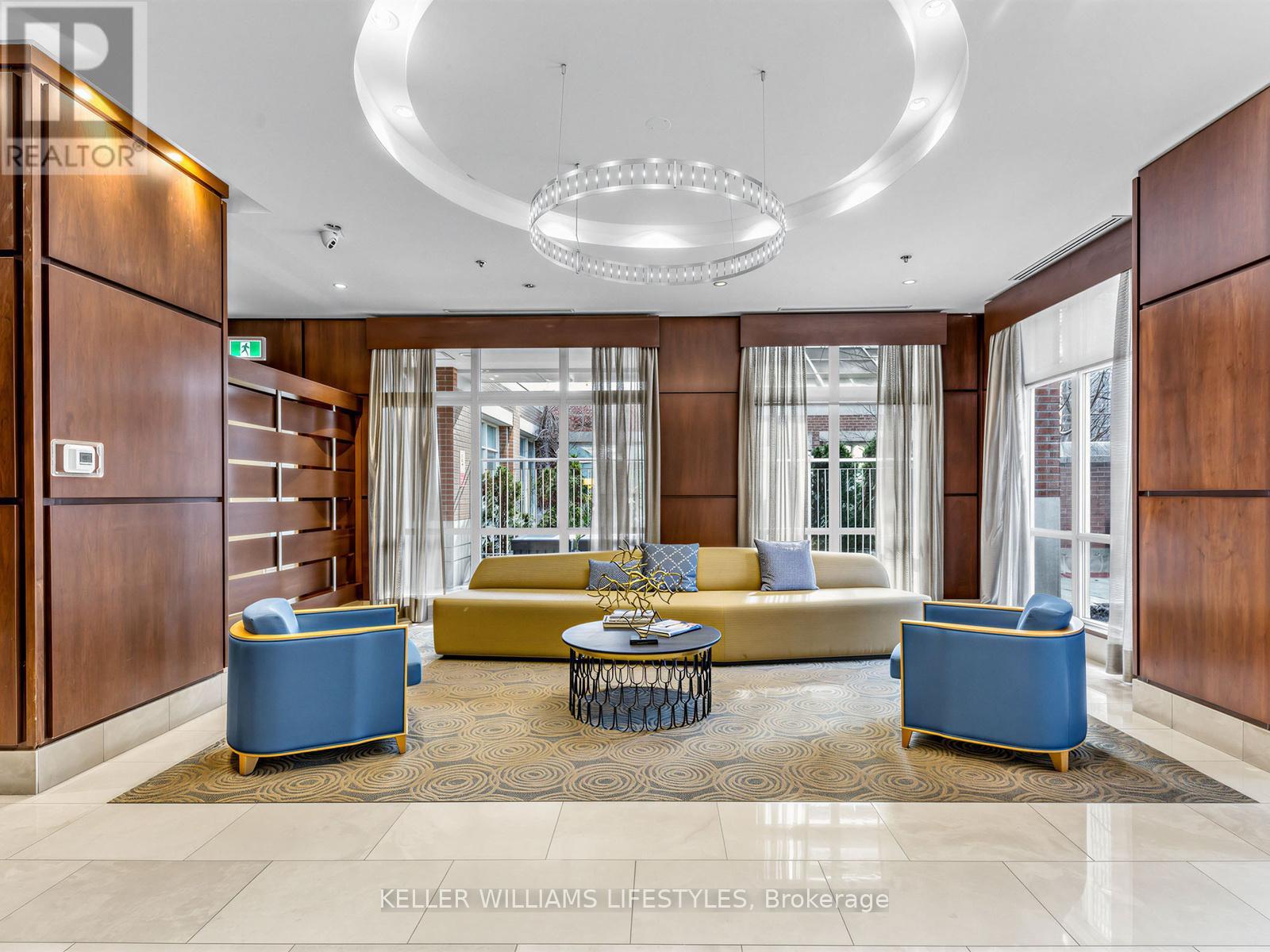 A large, well-lit room with a sofa, armchairs, and a coffee table.